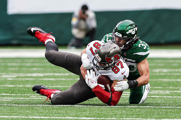 Jets safety Elijah Riley tackles Bucs tight end Rob Gronkowski